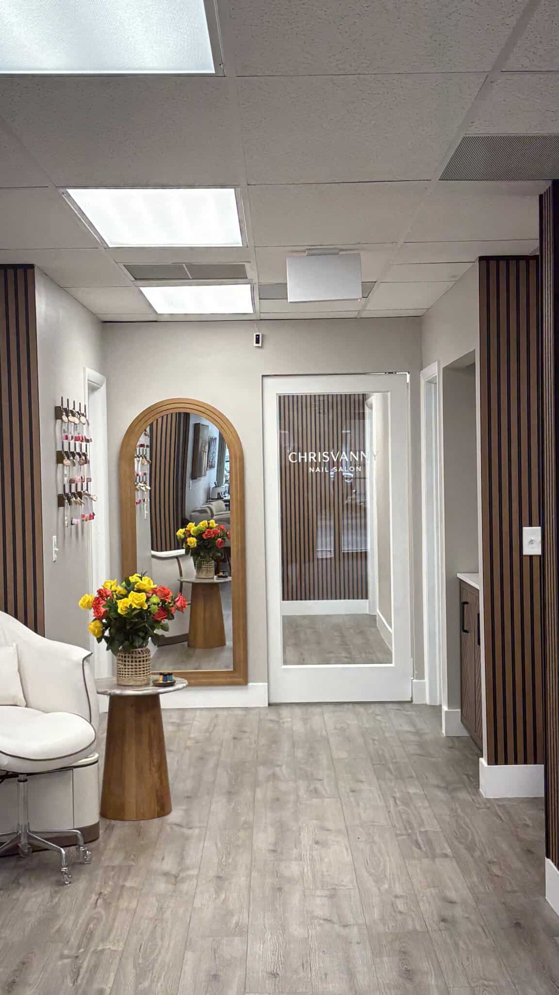 Reception area with floral arrangements and stylish decor at Salon Renter. Perfect for welcoming cli.