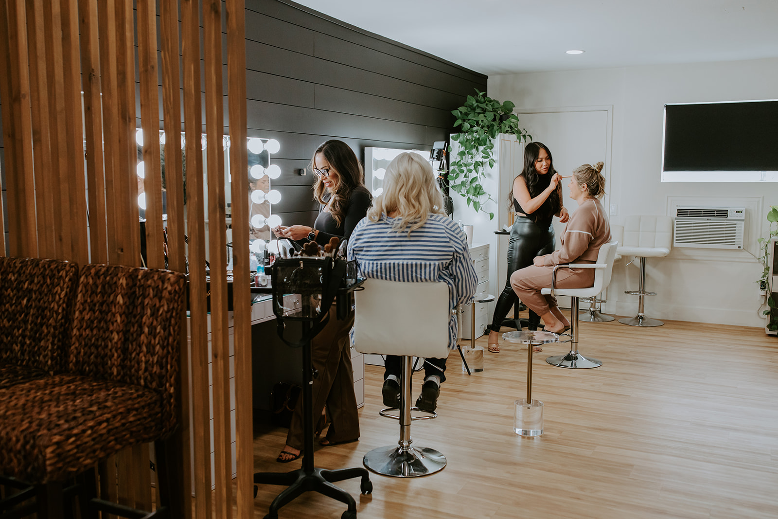 Elegant salon interior with clients and stylists at work, showcasing professional beauty services in.
