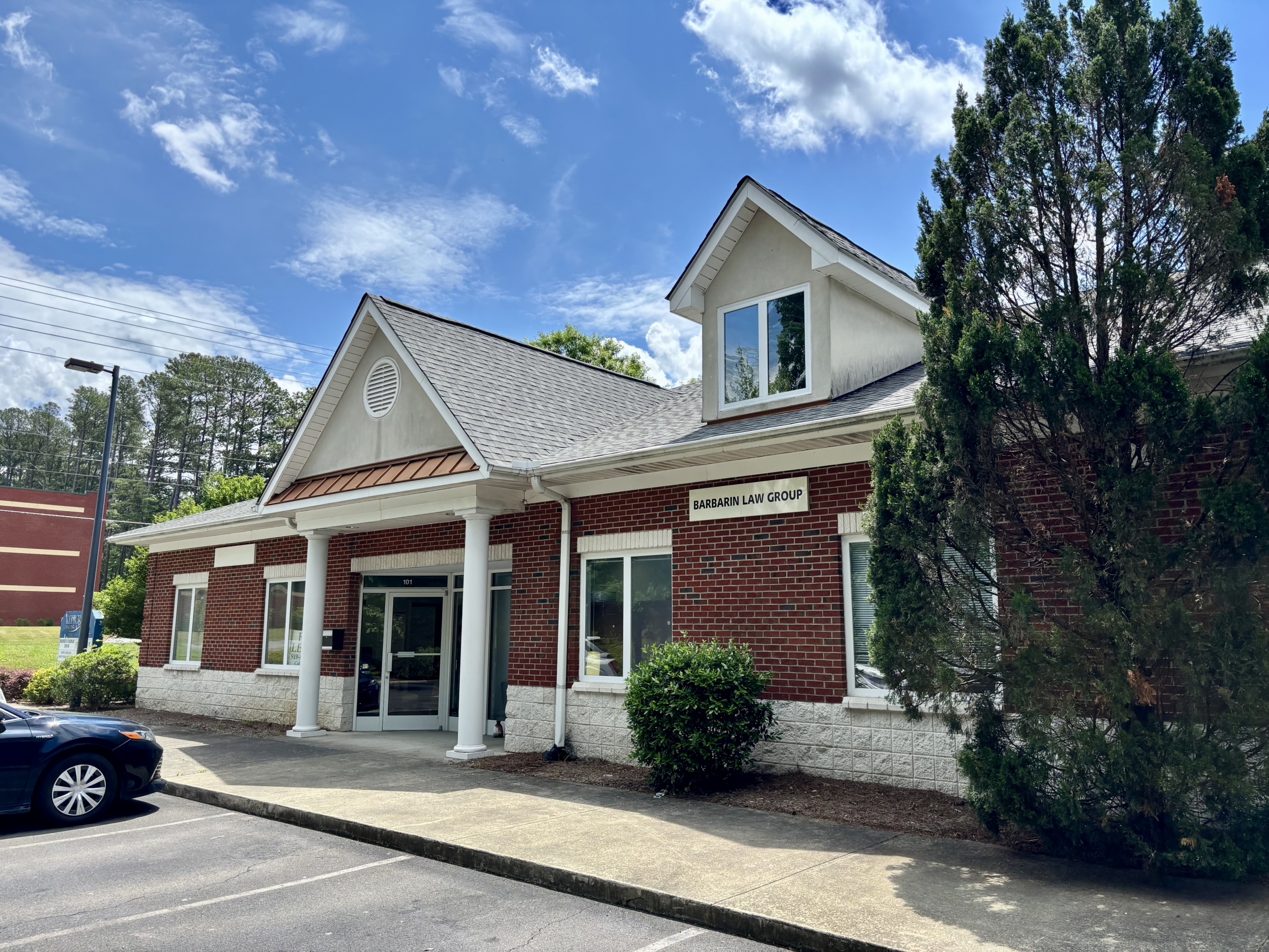 Modern salon renter office building with brick exterior and large windows.