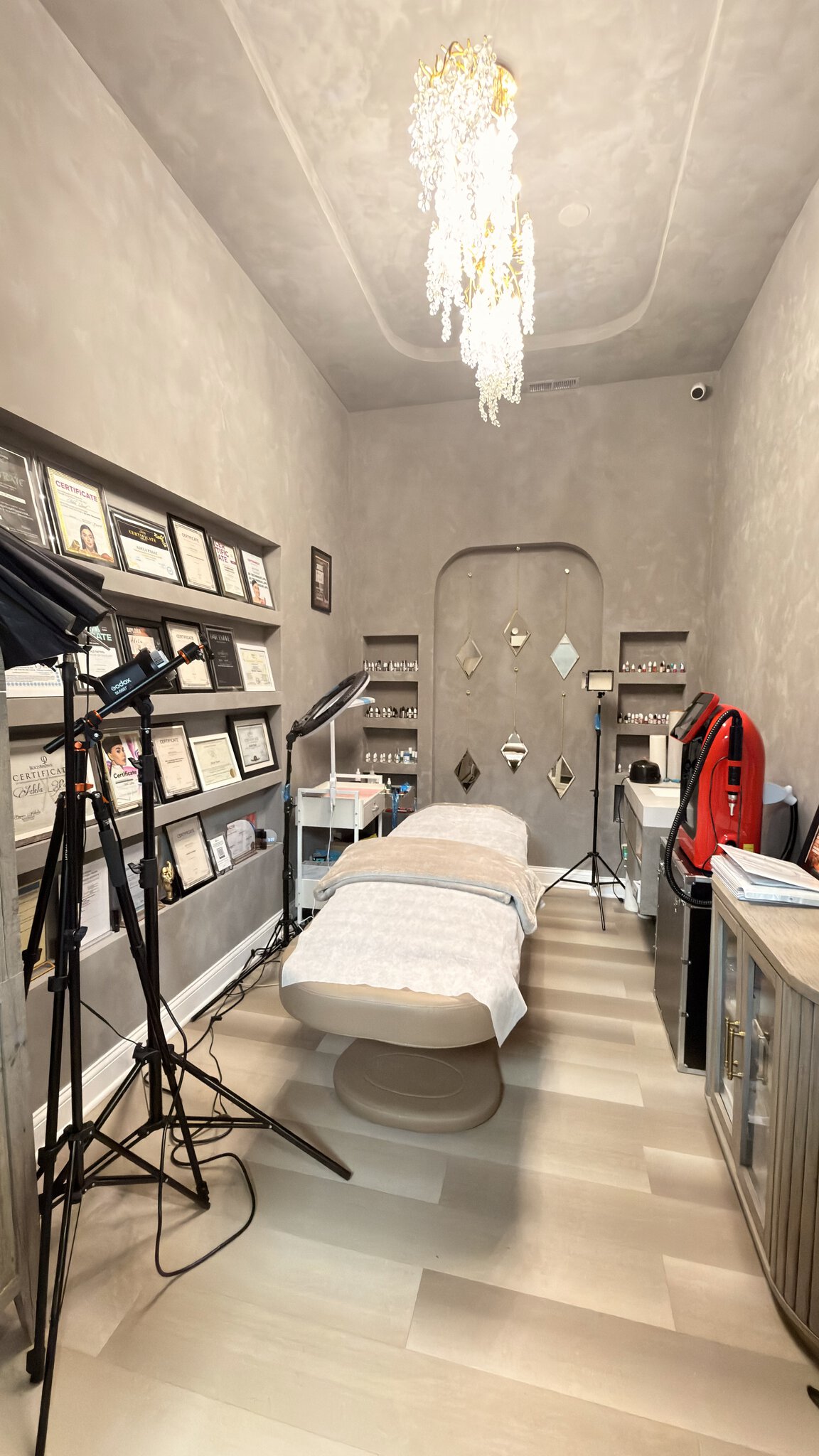 Modern salon treatment room with massage bed, professional lighting, and decor for client comfort an.