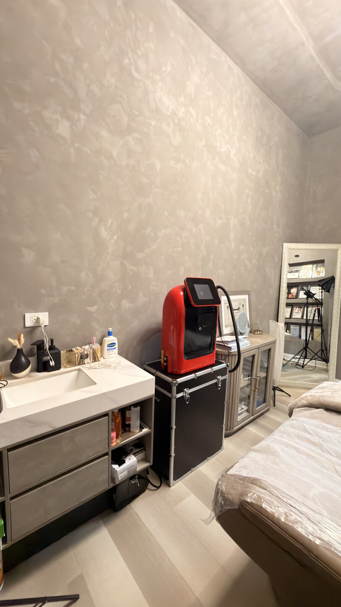 Salon Renter workspace with modern salon equipment, including a red coffee machine, sink, and storag.