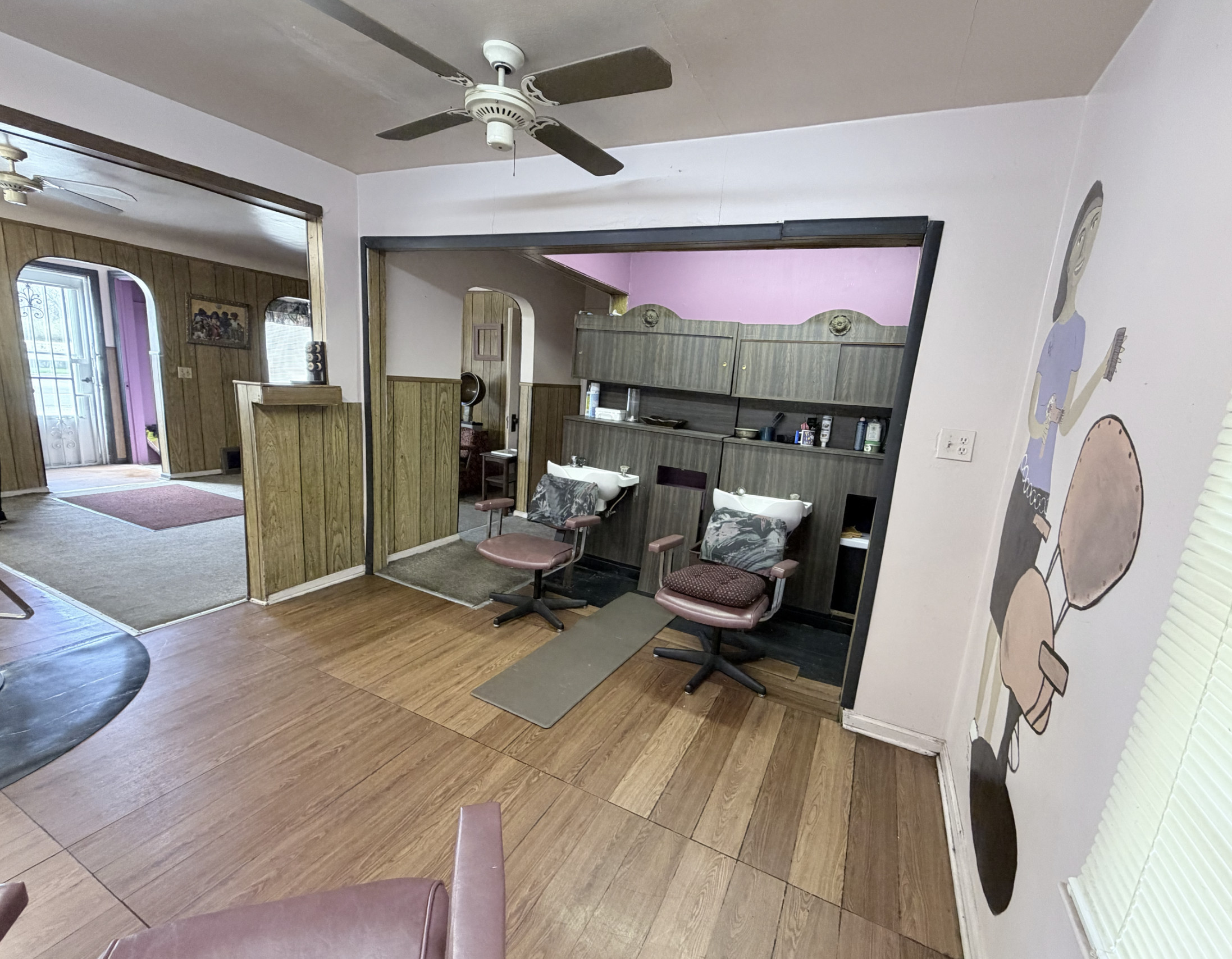 Office space for salon renters with chairs, wall decor, and a welcoming environment.