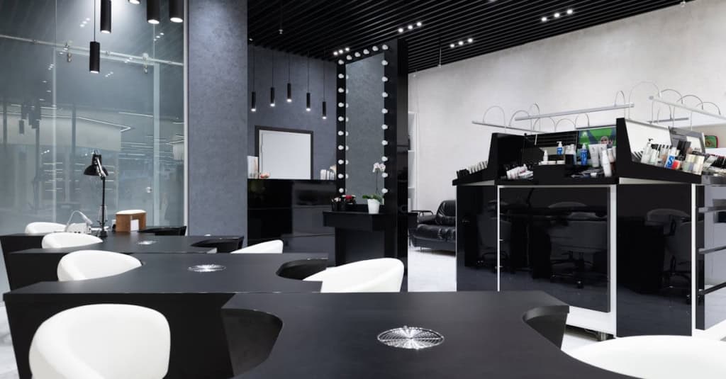 Modern salon interior featuring sleek workstations, contemporary lighting, and a professional atmosp.